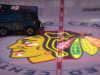 The ice is smoothed as the Chicago Blackhawks logo is illuminated before a game against the Nashville Predators at United Center on April 23, 2021, in Chicago.