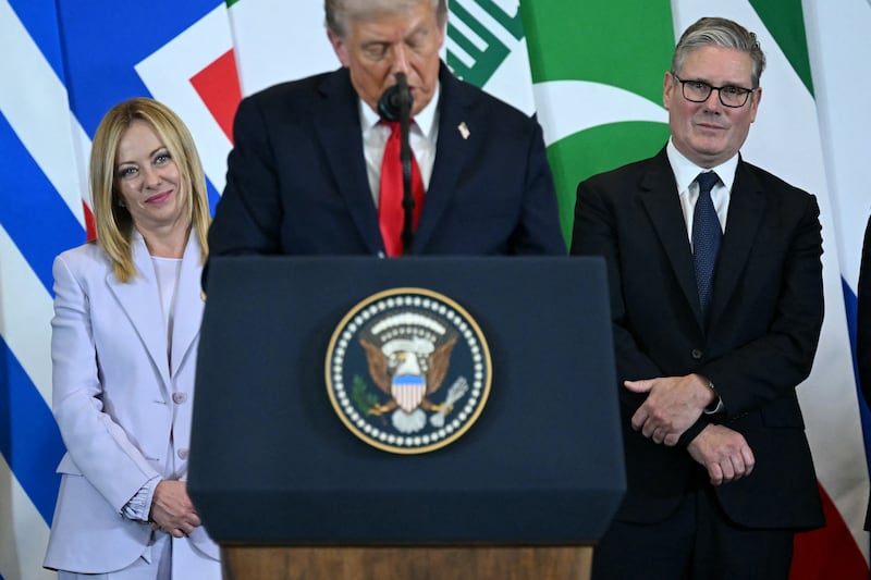 US President Donald Trump (C) speaks as Italian Prime Minister Giorgia Meloni (L) and Britain's Prime Minister Keir Starmer watch during the Sharm El-Sheikh Peace Summit in the Egyptian Red Sea resort town of Sharm el-Sheikh on October 13, 2025. Trump on October 13 hailed a Gaza summit in Egypt as a "tremendous day" for the Middle East, saying a document would be signed on "rules and regulations" for future talks. (Photo by SAUL LOEB / AFP) (Photo by SAUL LOEB/AFP via Getty Images)