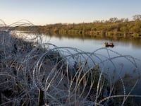 U.S. National Guard soldiers stop to talk while patrolling the Rio Grande at the U.S.-Mexico border