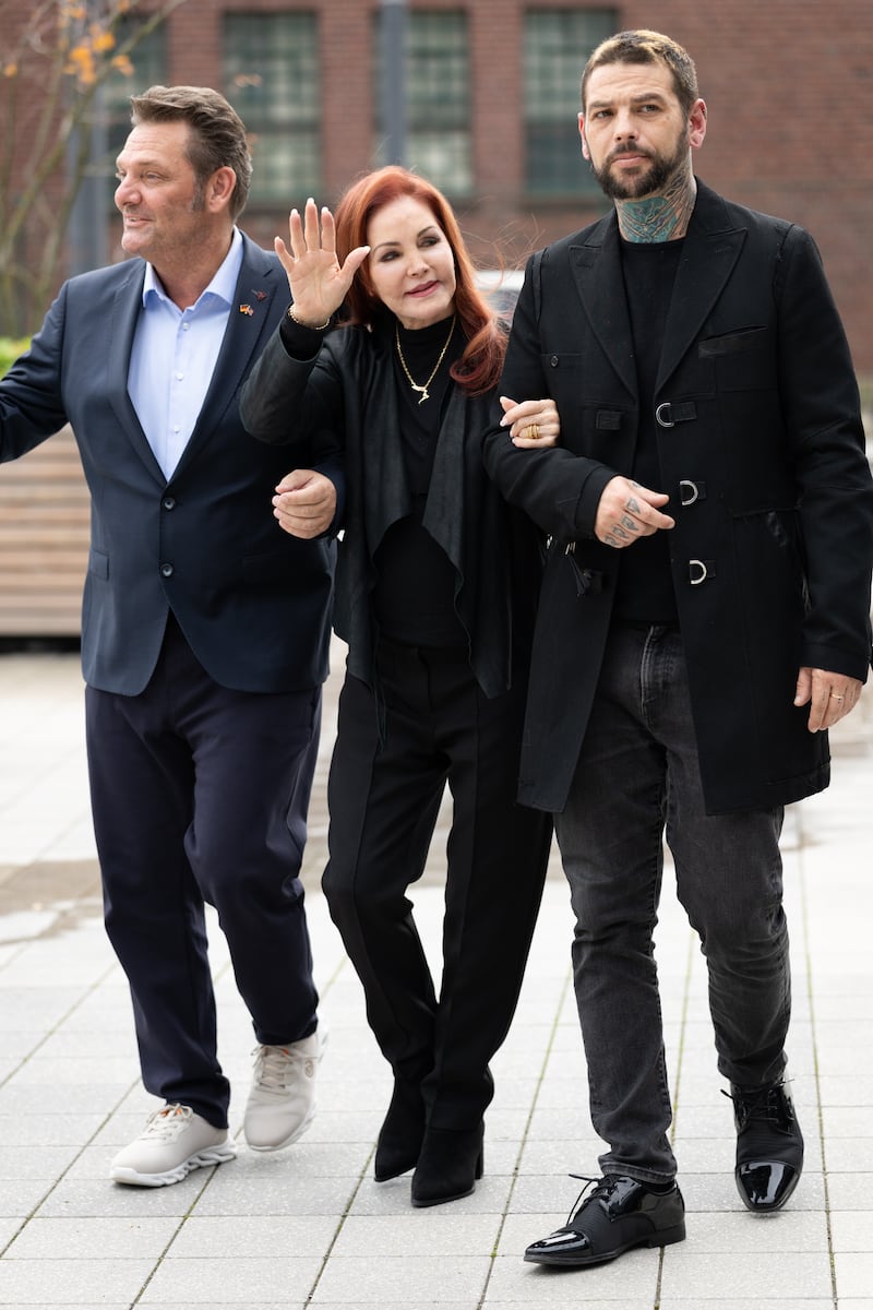 BAESWEILER, GERMANY - OCTOBER 20: (L-R) Detlef Malinkewitz, Priscilla Presley and her son Navarone Garibaldi Garcia attend a visit to Baesweiler on October 20, 2026 in Baesweiler, Germany. (Photo by Andreas Rentz/Getty Images)