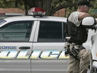 A St. George police officer stands watch outside the 5th Judicial District Courthouse for the start of the Warren Jeffs trial September 13, 2007 in St. George, Utah.