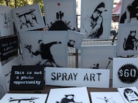 articles/2013/10/14/banksy-s-biggest-trick-yet-selling-his-art-on-the-street-for-60/131014-banksy-stall-wilkinson-tease_oyp7c7