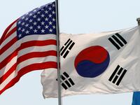 Flags of the U.S., South Korea, and the United Nations (L to R) flap in the wind at the Korean War Memorial Museum in Seoul, May 26, 2009.