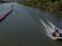 Texas Department of Public Safety (DPS) troopers ride past buoys while patrolling the Rio Grande river along the international boundary of the United States and Mexico near Eagle Pass, Texas, U.S. July 29, 2023.