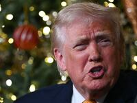 US President Donald Trump participates in NORAD Santa tracker phone calls, on Christmas Eve, from the Mar-a-lago club in Palm Beach, Florida, on December 24, 2025. (Photo by ANDREW CABALLERO-REYNOLDS / AFP via Getty Images)