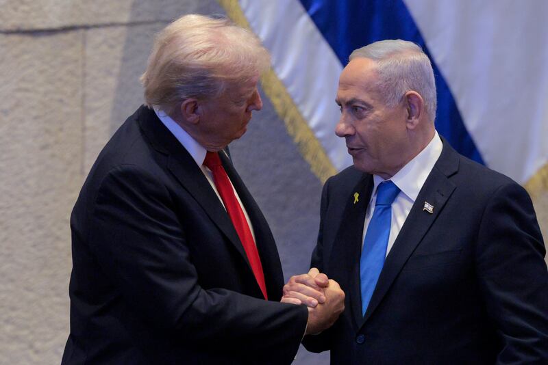 President Donald Trump Israeli and Prime Minister Benjamin Netanyahu interact after Netanyahu addressed the Knesset on October 13, 2025 in Jerusalem.