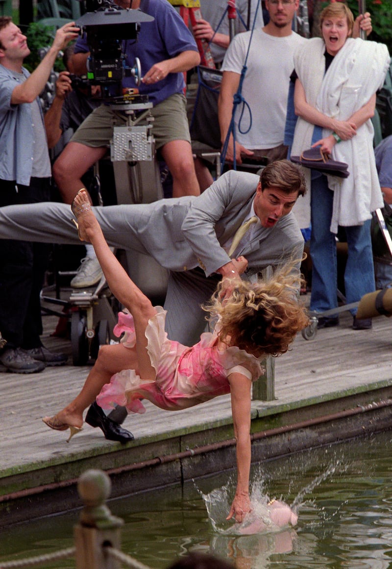 Sarah Jessica Parker, as Carrie Bradshaw, and Chris Noth, John James Preston or Mr. Big, fall into Central Park Lake filming a scene for Sex & the City, NYC July 24, 2000. Exclusive (Photo by Lawrence Schwartzwald/Sygma via Getty Images)