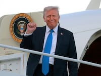 U.S. President Donald Trump disembarks from Air Force One.
