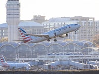 American Airlines Boeing 737 MAX 8 passenger aircraft spotted during takeoff and flying in front of the airport terminal, air traffic control tower and planes from Ronald Reagan Washington National Airport DCA, the closest airport to US capital Washington, D.C,. The AA narrow body airplane has the registration tail number N321TG and is powered by 2x CFMI LEAP 1B jet engines. American Airlines AAL is a major airline in the United States with headquarters and main hub in Fort Worth, Texas, USA. American Airlines is the largest airline in the world with a fleet of 970 planes, operating regional subsidiaries with the brand name American Eagle, member of Oneworld aviation alliance group. Crystal City, Virginia, United States on November 8, 2024.
