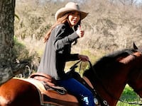 US Homeland Security Secretary Kristi Noem gives a thumbs-up as she rides a horse during her visit to the Campo De Mayo Military Base in San Miguel, Buenos Aires province, Argentina, on July 28, 2025. Noem is on a diplomatic tour of several South American countries, with stops planned in Argentina, Chile, and Ecuador. (Photo by Alex Brandon / POOL / AFP)