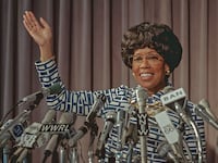 Regina King as Shirley Chisholm stands at a press conference in a still from ‘Shirley’