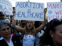 An abortion rights protester holds a sign as she demonstrates after the U.S. Supreme Court ruled in the Dobbs v Women’s Health Organization abortion case, overturning the landmark Roe v Wade abortion decision in Miami.