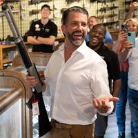 Donald Trump Jr., son of US President Donald Trump, holds a shotgun at Tombstone Tactical gun store in Phoenix, Arizona, on October 23, 2024.