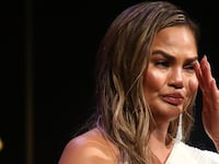 Chrissy Teigen crying on stage.