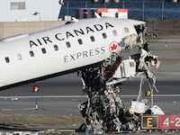 NEW YORK, NEW YORK - MARCH 24: An Air Canada Express CRJ-900 sits on the runway after colliding with a Port Authority fire truck at LaGuardia Airport on March 24, 2026 in New York City. Flights into and out of LaGuardia airport have resumed after an Air Canada Express plane flight from Montreal collided with a fire truck on the tarmac killing the pilot as well as the co-pilot and leaving more than forty people injured. (Photo by Michael M. Santiago/Getty Images)