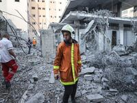 A man searches through the rubble after Israeli airstrikes hit Gaza, a day after Hamas militants invaded Israel.