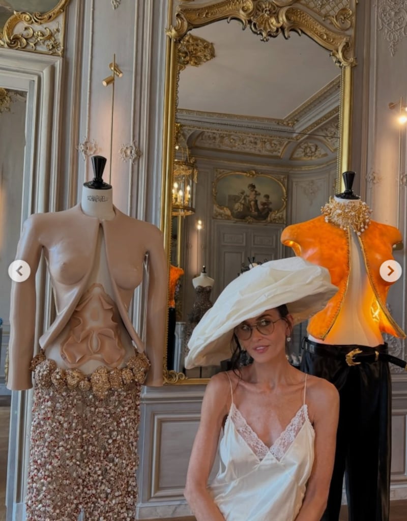 Demi Moore showed off a plunging neckline alongside Schiaparelli designs.