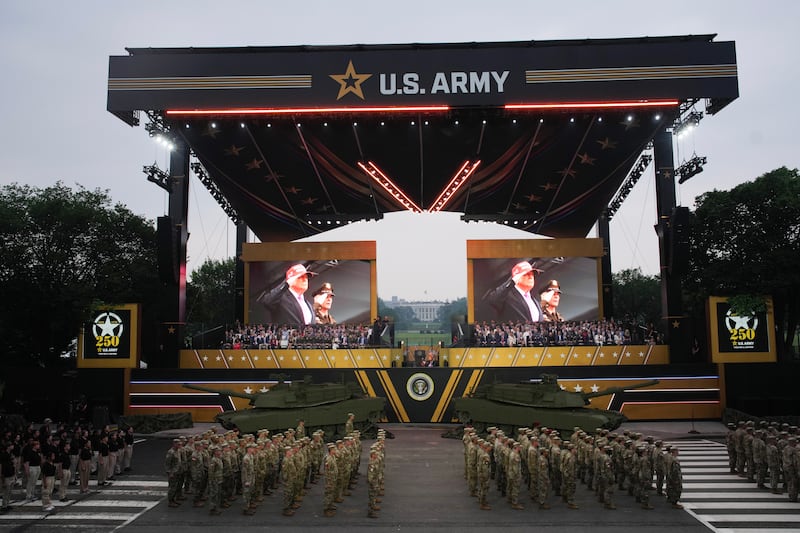 President Donald Trump and guests watch as members of the U.S Army parade down Constitution Avenue marking the 250th birthday of the U.S. Army June 14, 2025 in Washington, DC.