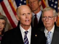 Senator Rick Scott (R-FL) speaks to reporters as Senators Joni Ernst (R-IA), John Thune (R-SD) and Senate Minority Leader Mitch McConnell (R-KY) listen at the U.S. Capitol in Washington.