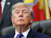 President Donald Trump listens