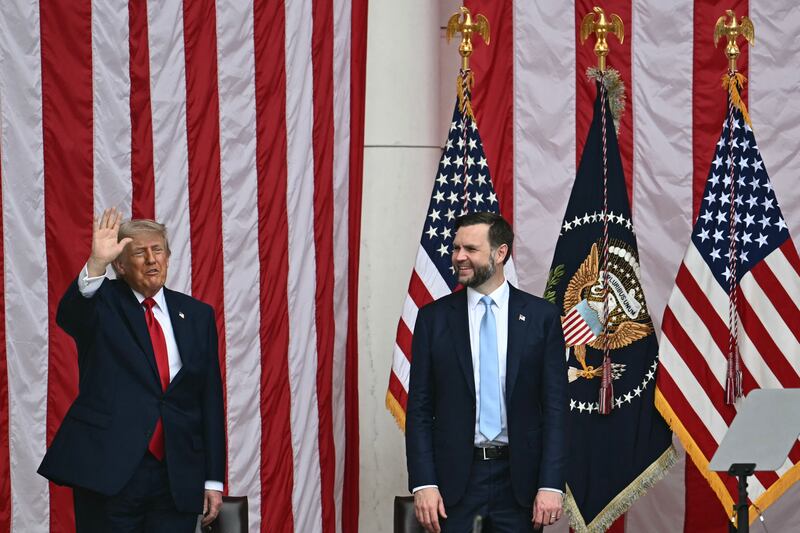 US President Donald Trump waves alongside Vice President JD Vance during the National Memorial Day Observance at the Memorial Amphitheatre in Arlington National Cemetery in Arlington, Virginia on May 25, 2026. (Photo by Kent NISHIMURA / AFP via Getty Images)