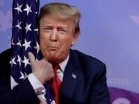 Donald Trump hugs American flag at the Conservative Political Action Conference (CPAC) annual meeting at National Harbor near Washington, D.C., March 2, 2019.