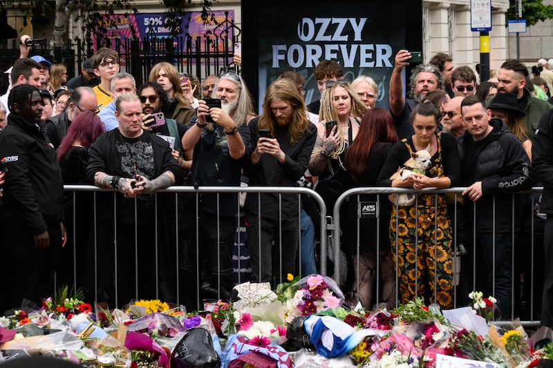 BIRMINGHAM, ENGLAND - JULY 30: Fans gather at Black Sabbath Bridge after members of the Osbourne family visit to view tributes to the late Ozzy Osbourne as his funeral cortege travelled through his home city of Birmingham on July 30, 2025 in Birmingham, England. The Black Sabbath frontman passed away on July 22nd at the age of 76. His death occurred just a little over two weeks after his final live performance at the 'Back to the Beginning' concert in his hometown of Birmingham. (Photo by Leon Neal/Getty Images)