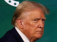 Donald Trump stares to his right while exiting a stage