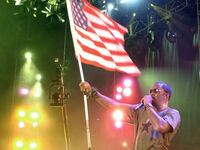 Sean "P. Diddy" Combs performs while waving an American flag.