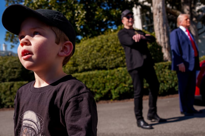 WASHINGTON, DC - MARCH 11: X Æ A-Xii, the son of White House Senior Advisor, Tesla and SpaceX CEO Elon Musk, walks across the driveway as Musk and U.S. President Donald Trump speak alongside a Tesla Model Y on the South Lawn of the White House on March 11, 2025 in Washington, DC.