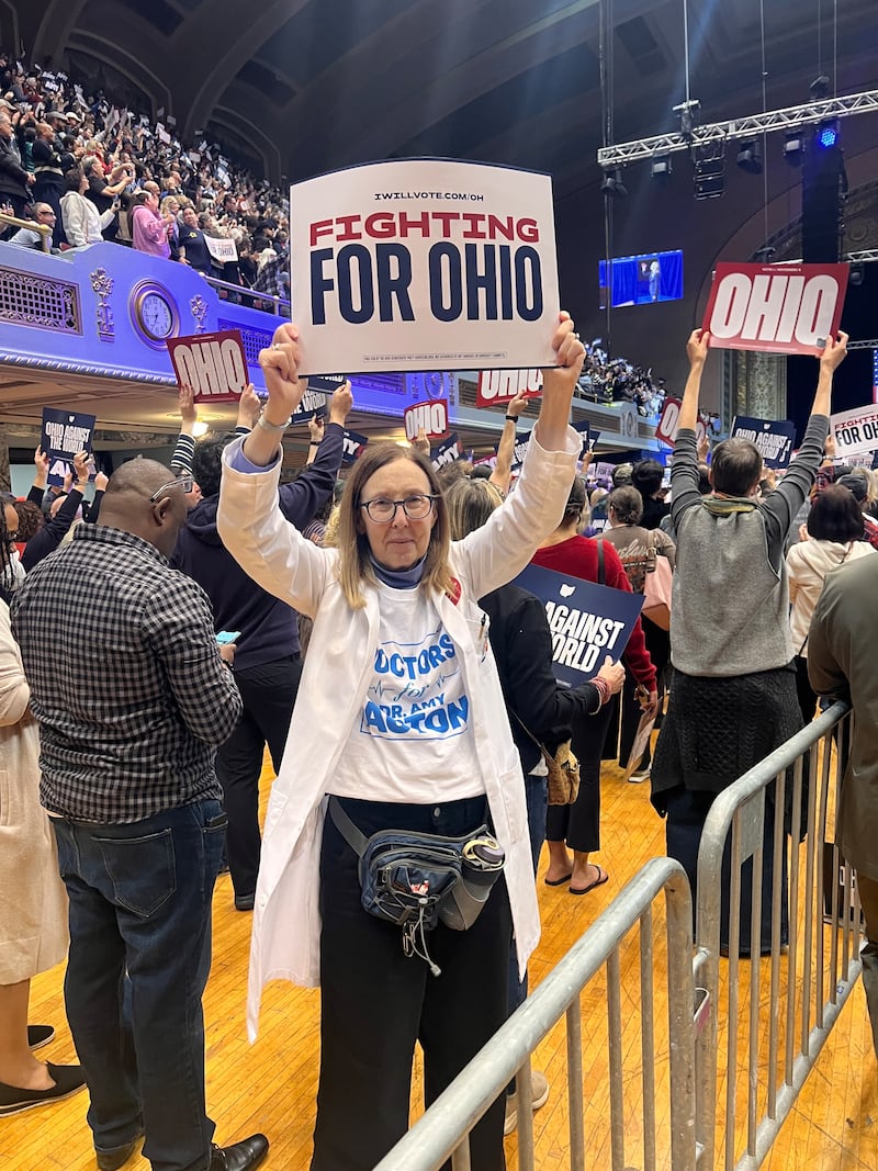 Ohio resident Patricia Kellner attended the rally sporting a white coat and a “Doctors for Dr Amy Acton" t-shirt.