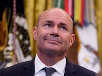 Sen. Mike Lee (R-UT) (L), and Utah Gov. Spencer Cox (R) stand behind U.S. President Donald Trump (C) as he speaks to members of the media during an executive order signing in the Oval Office of the White House on July 13, 2026 in Washington, DC. Trump signed two executive orders related to the transfer of federal land to the State of Utah.