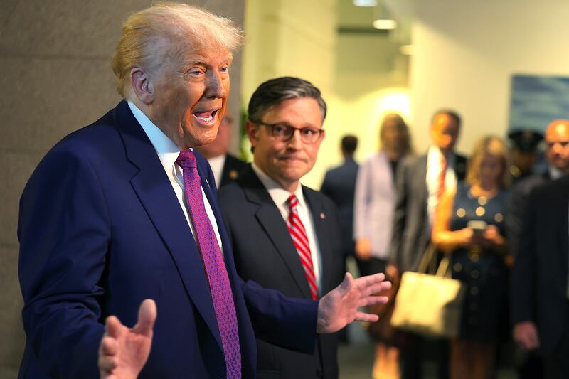 With Speaker of the House Mike Johnson (R-LA) by his side President Donald Trump speaks to the press.