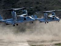 A couple MV-22 Osprey aircraft kick up dust while landing during the annual Steel Knight training exercise at Camp Pendleton.