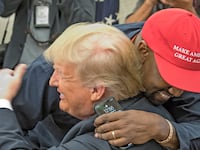 Kanye West embraces real estate developer and US President Donald Trump in the White House's Oval Office, Washington DC, October 11, 2018.