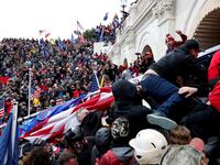 A horde of Donald Trump supporters clash with police as they try to storm the Capitol