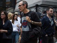 Terry Richardson walks into a Fashion Week in 2017 wearing glasses.