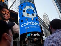People watch as the logo for Coinbase Global Inc, the biggest U.S. cryptocurrency exchange, is displayed on the Nasdaq MarketSite jumbotron at Times Square in New York, U.S., April 14, 2021.