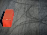 Red container on a dock.