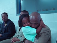 A still of a father and daughter hugging in the film 'Daughters'