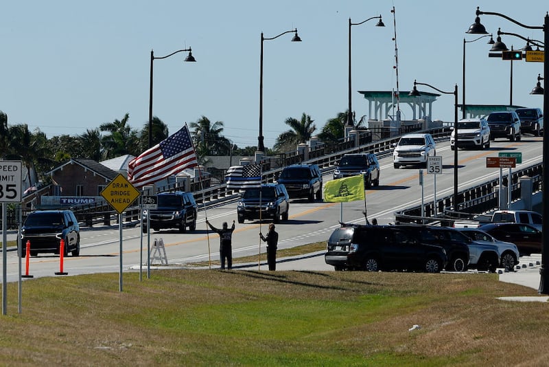 PALM BEACH, FLORIDA - DECEMBER 03: Supporters wave at President-elect Donald Trump's motorcade as it passes along Southern Boulevard on Bingham Island as it returns to Trump's Mar-a-lago Club on December 03, 2024 in Palm Beach, Florida. Trump attended a memorial service on Tuesday for three Palm Beach County sheriff's deputies killed last month in a roadside crash. (Photo by Chip Somodevilla/Getty Images)