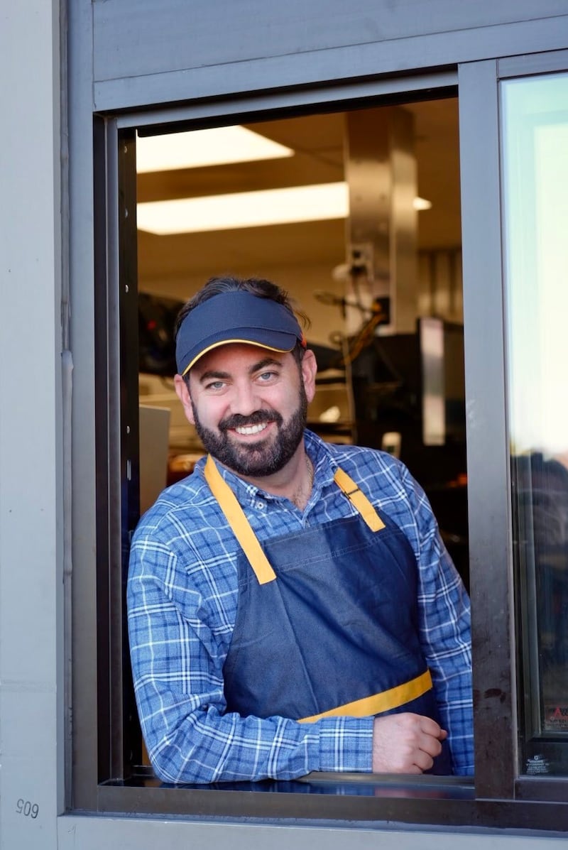 GOP New York Rep. Mike Lawler poses at a McDonald's drive-thru window