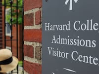 A sign points the way to the Harvard College Admissions Visitors Center at Harvard University in Cambridge, Massachusetts, July 6, 2023.