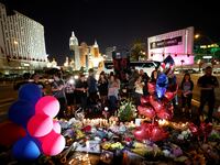 People gather at a makeshift memorial in the middle of Las Vegas Boulevard following the mass shooting in Las Vegas, Nevada, U.S., October 4, 2017.