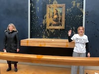Protestors stand alongside the Mona Lisa.