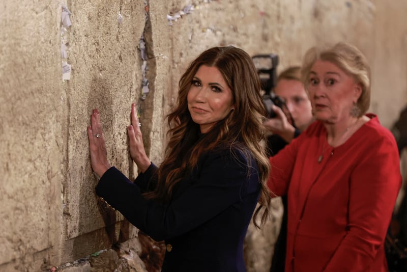 Kristi Noem (C) and Janet Huckabee, wife of the US Ambassador to Israel (R) visit the Western Wall in Jerusalem, the holiest site where Jews are allowed to pray.