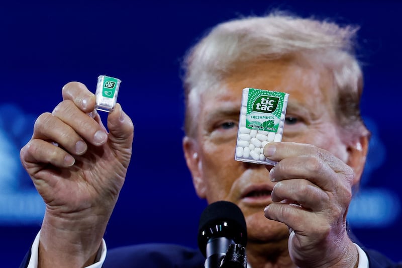 Former U.S. President and Republican presidential candidate Donald Trump holds Tic Tac containers while talking about inflation.