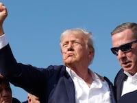 Republican presidential candidate former President Donald Trump pumps his fist as he is rushed offstage during a rally on July 13, 2024 in Butler, Pennsylvania.