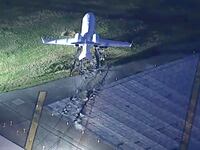 View of a plane that has skidded off a runway.