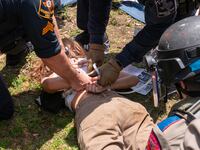 A pro-Palestinian protestor is arrested by Texas State troopers and university police at the University of Texas in Austin.